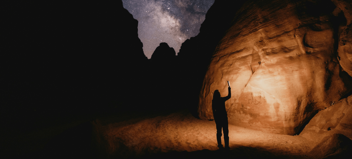A woman wall paintings in the dessert exhibition at night